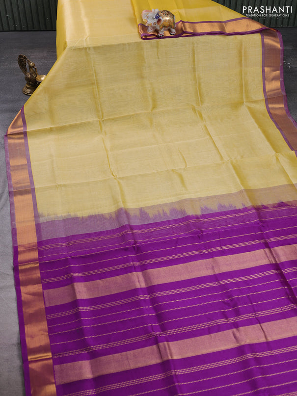 Silk cotton saree pale yellow and purple with plain body and zari woven border