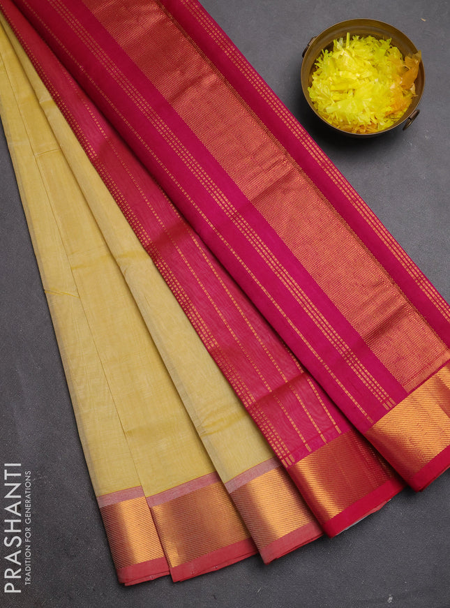 Silk cotton saree pale yellow and magenta pink with plain body and zari woven border
