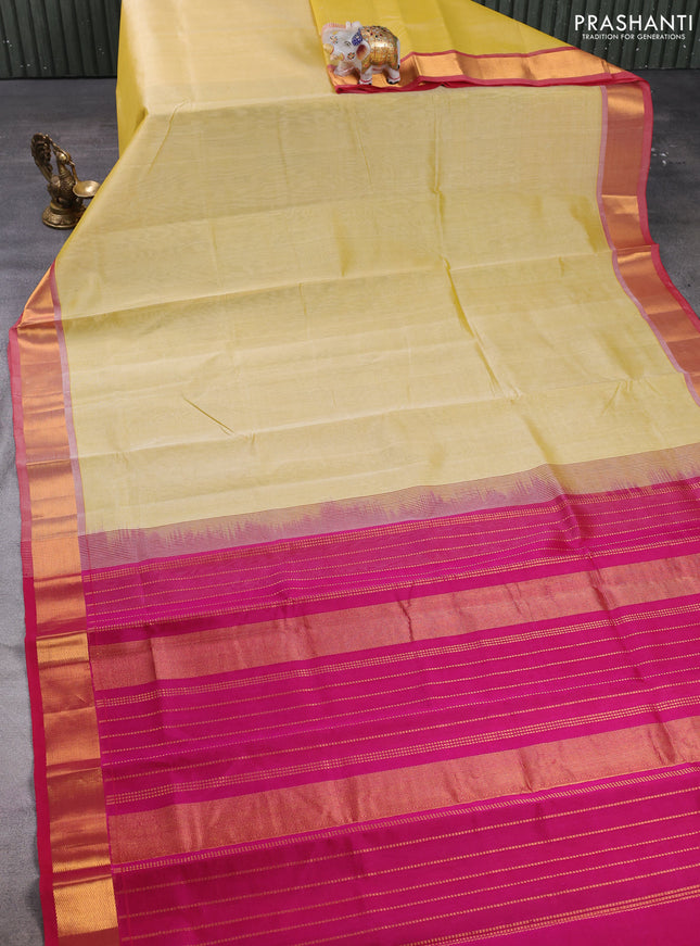 Silk cotton saree pale yellow and magenta pink with plain body and zari woven border