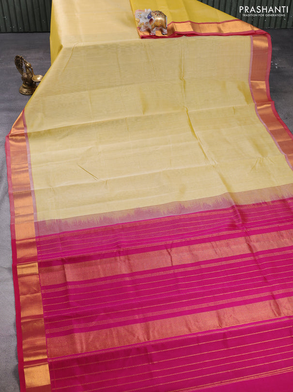 Silk cotton saree pale yellow and magenta pink with plain body and zari woven border