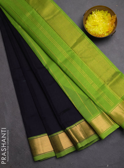Silk cotton saree black and light green with plain body and zari woven border