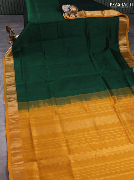 Silk cotton saree bottle green and mustard green with plain body and zari woven border