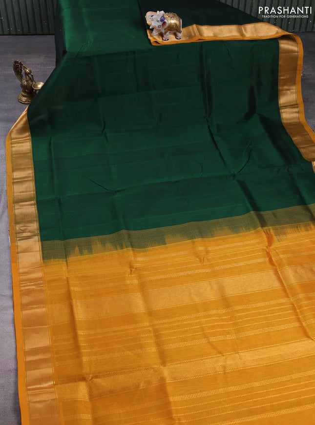 Silk cotton saree bottle green and mustard green with plain body and zari woven border