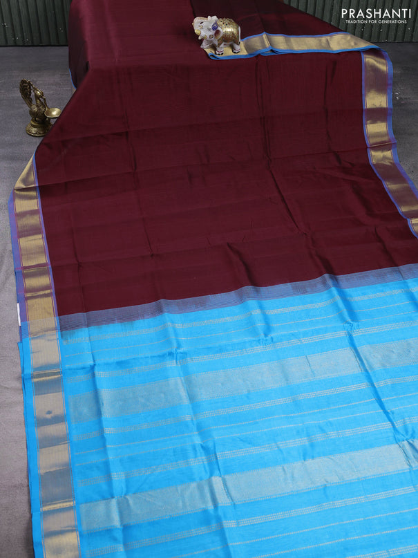 Silk cotton saree maroon and cs blue with plain body and zari woven border