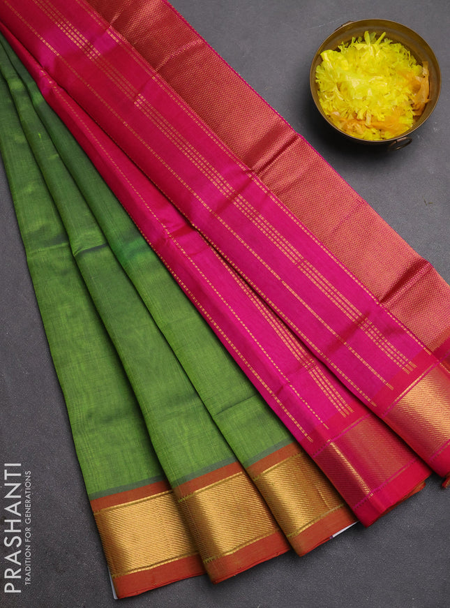 Silk cotton saree green and pink with plain body and zari woven border