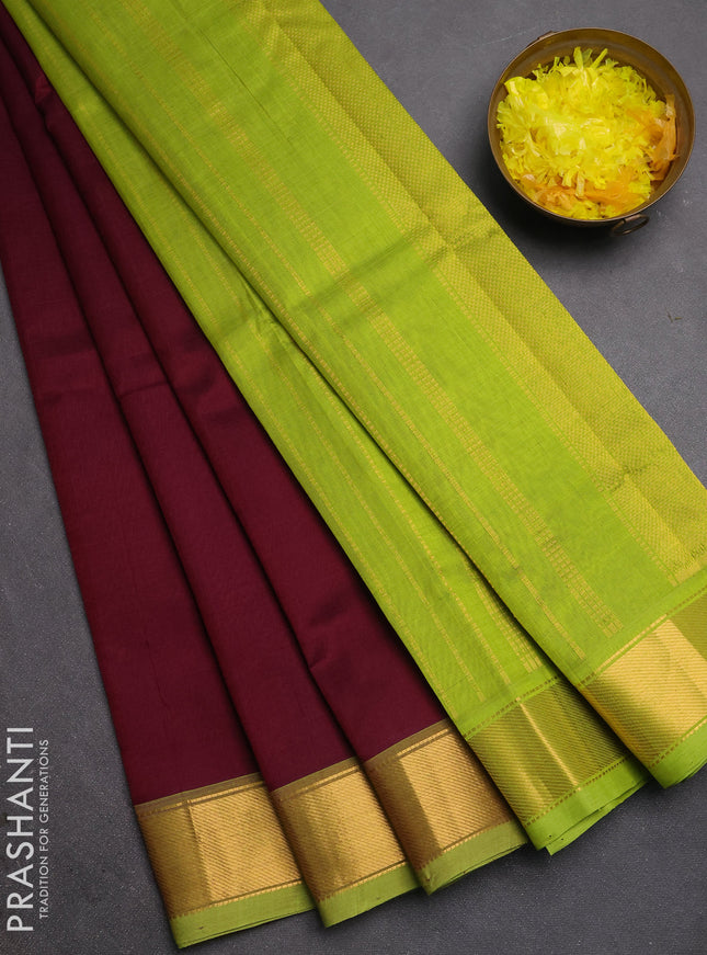 Silk cotton saree deep wine and light green with plain body and zari woven border