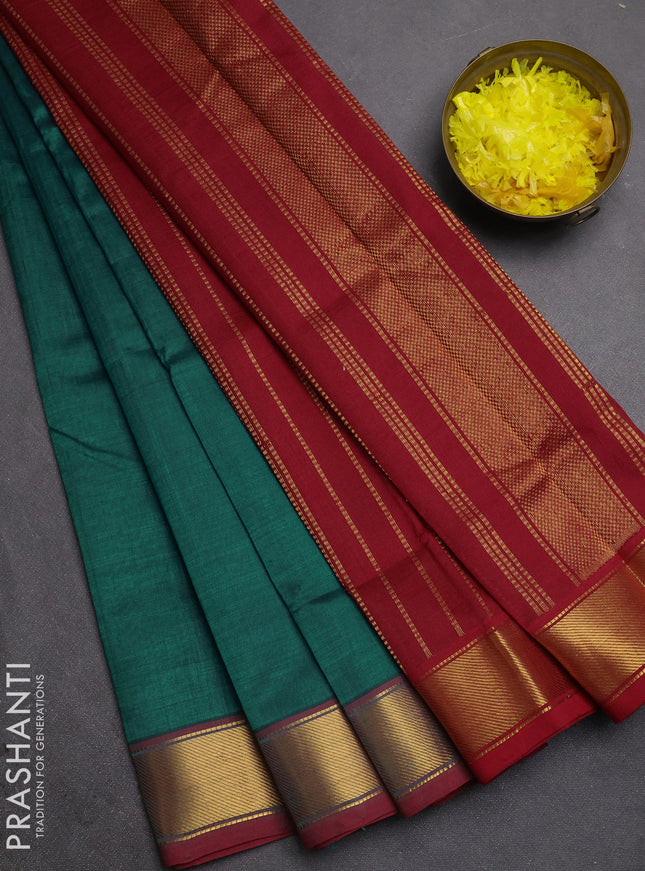 Silk cotton saree peacock green and maroon with plain body and zari woven border