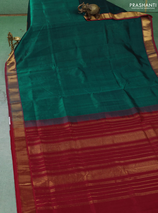 Silk cotton saree peacock green and maroon with plain body and zari woven border