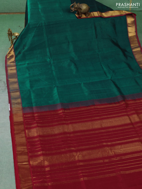 Silk cotton saree peacock green and maroon with plain body and zari woven border