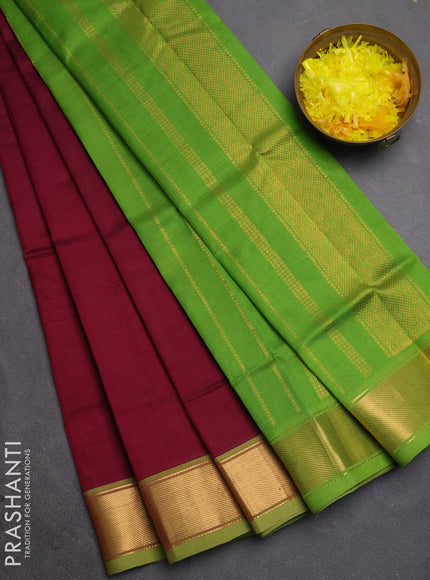 Silk cotton saree wine shade and light green with plain body and zari woven border