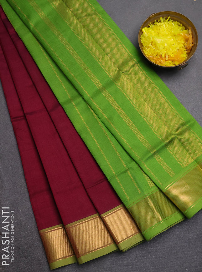 Silk cotton saree wine shade and light green with plain body and zari woven border