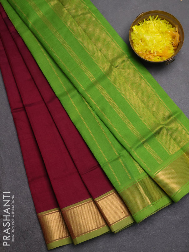 Silk cotton saree wine shade and light green with plain body and zari woven border