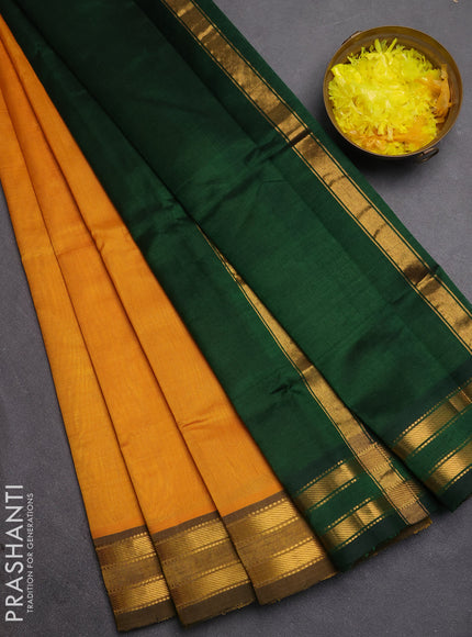 Silk cotton saree mustard yellow and bottle green with plain body and zari woven border