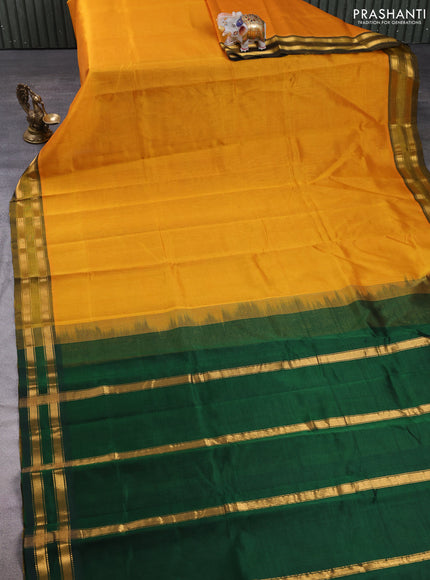 Silk cotton saree mustard yellow and bottle green with plain body and zari woven border