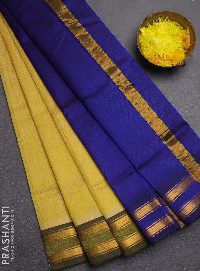Silk cotton saree pale yellow and royal blue with plain body and zari woven border