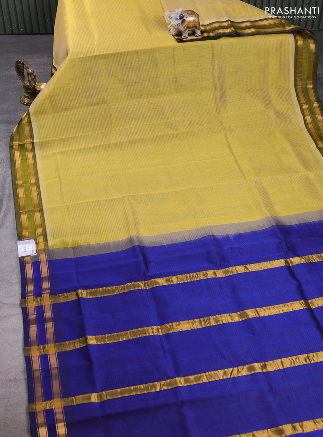 Silk cotton saree pale yellow and royal blue with plain body and zari woven border