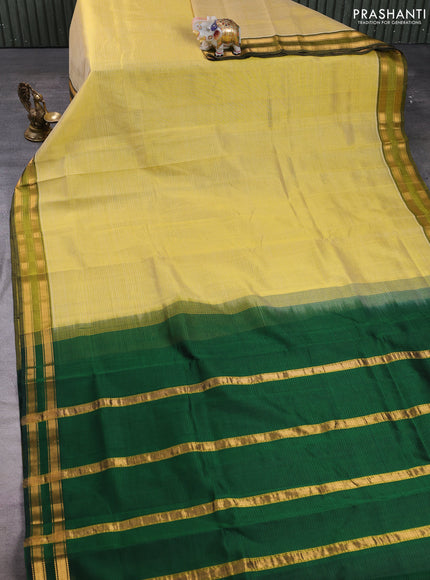 Silk cotton saree pale yellow and bottle green with plain body and zari woven border