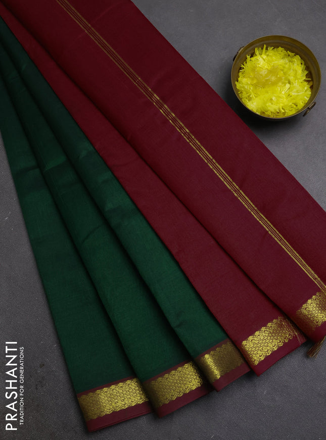 Silk cotton saree bottle green and maroon with plain body and zari woven border