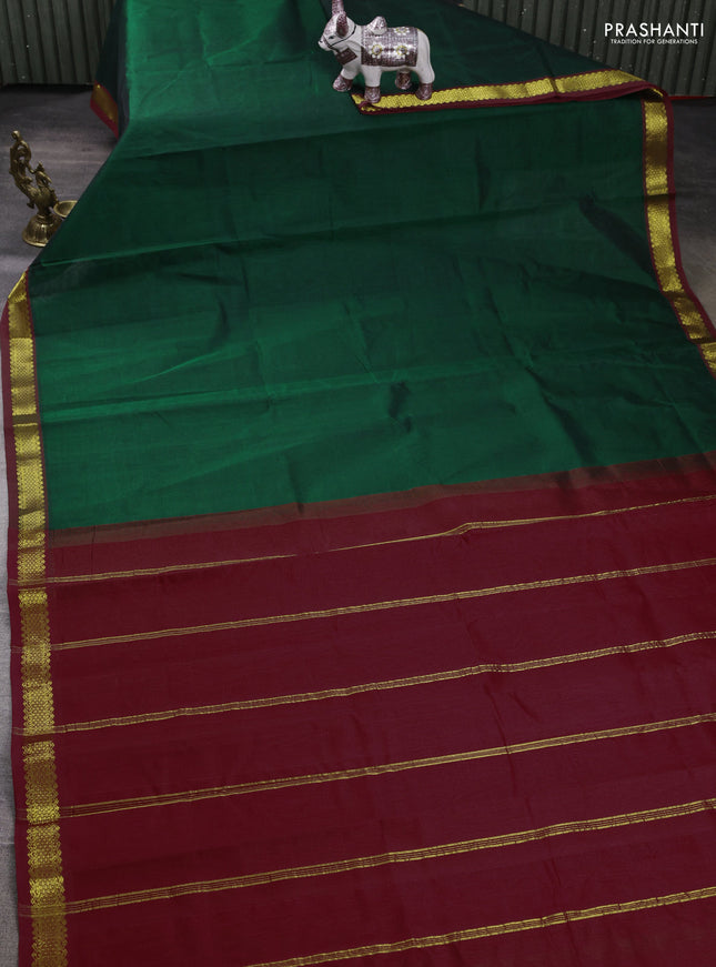 Silk cotton saree bottle green and maroon with plain body and zari woven border