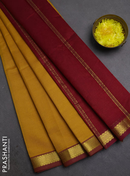 Silk cotton saree mustard yellow and maroon with plain body and zari woven border