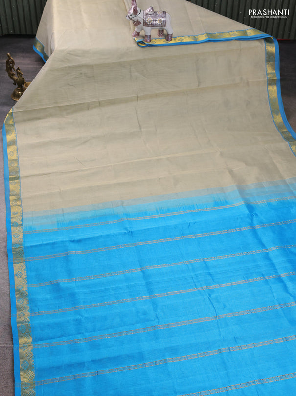 Silk cotton saree beige and cs blue with plain body and zari woven border