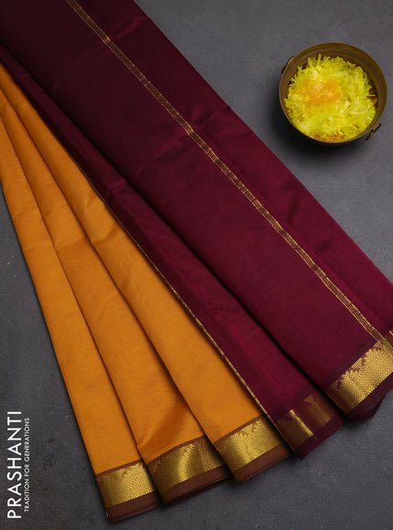 Silk cotton saree mustard yellow and wine shade with plain body and zari woven border