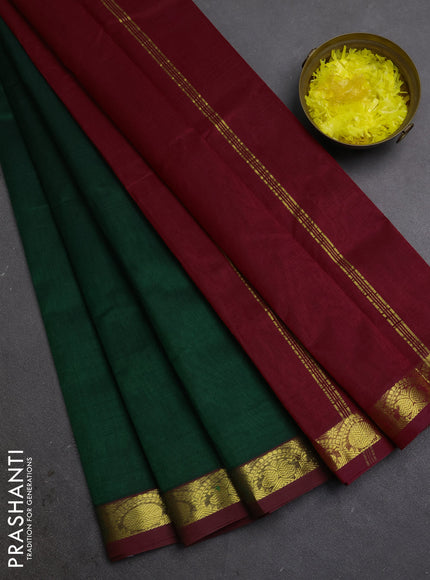 Silk cotton saree bottle green and kumkum red with plain body and zari woven border