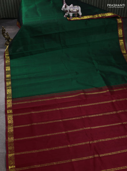 Silk cotton saree bottle green and kumkum red with plain body and zari woven border