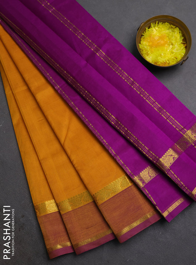 Silk cotton saree mustard yellow and purple with plain body and rettapet zari woven border