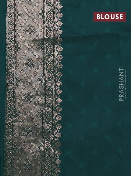 Semi soft silk saree bottle green with allover zari woven buttas and zari woven butta border