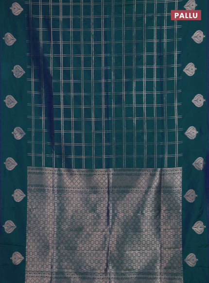 Semi soft silk saree peacock green with allover zari woven checked pattern and zari woven butta border