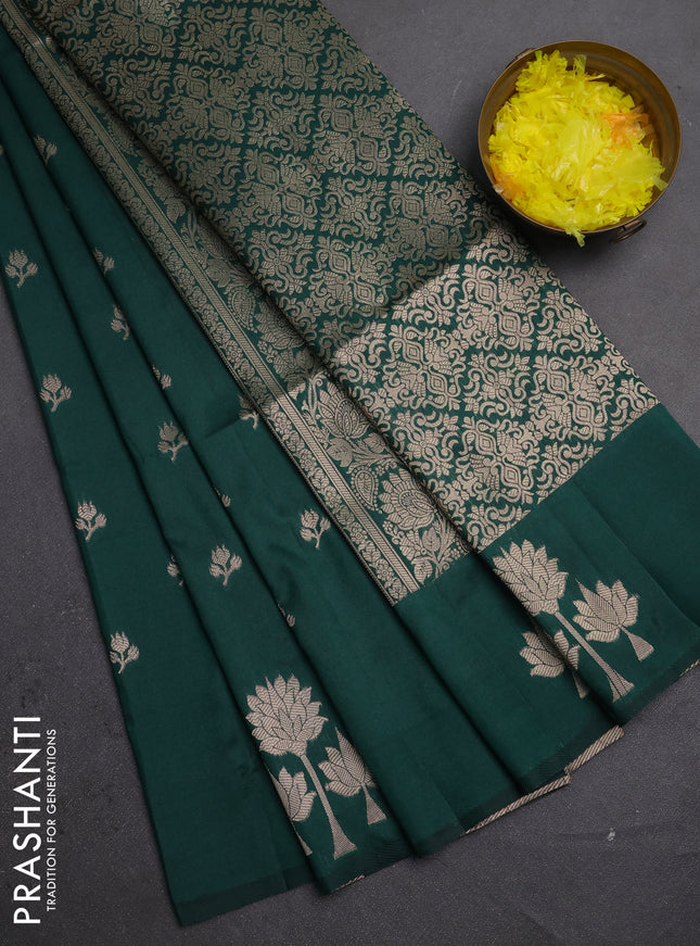 Semi soft silk saree bottle green with allover zari woven buttas and zari woven butta border