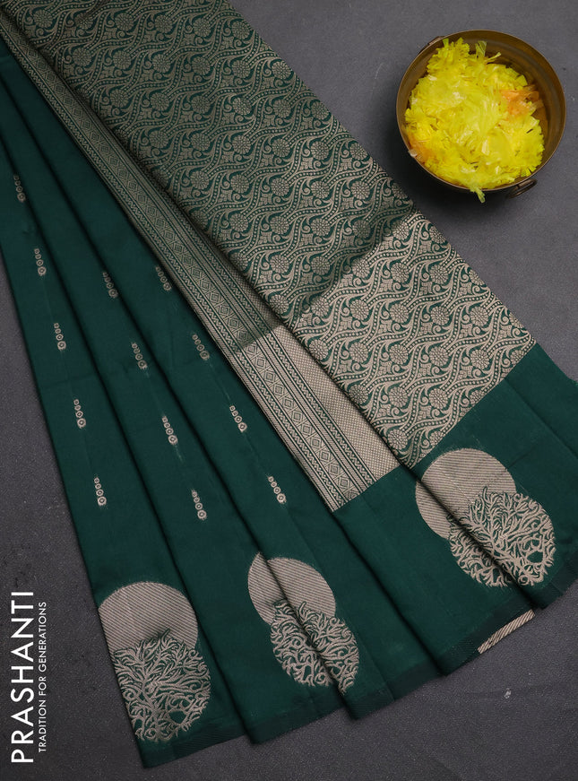 Semi soft silk saree bottle green with allover zari woven buttas and zari woven butta border