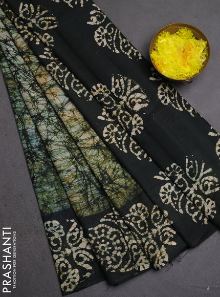 Batik cotton saree bottle green with allover prints and batik printed border