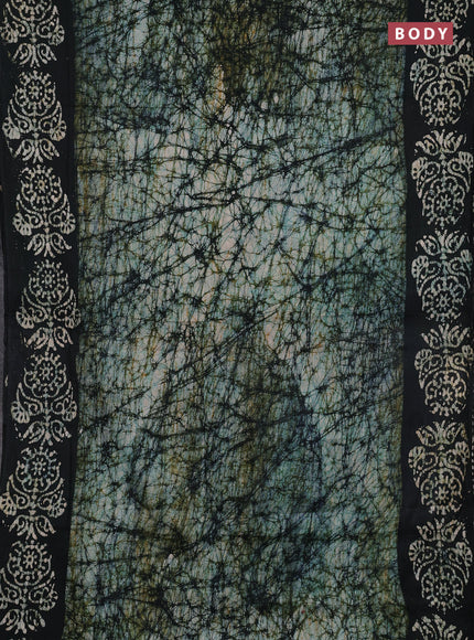 Batik cotton saree bottle green with allover prints and batik printed border