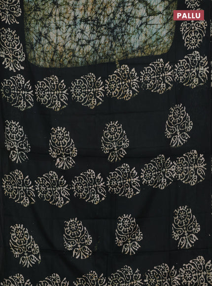 Batik cotton saree bottle green with allover prints and batik printed border