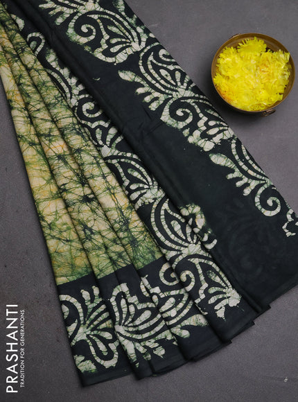 Batik cotton saree bottle green with allover prints and batik printed border