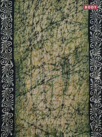 Batik cotton saree bottle green with allover prints and batik printed border