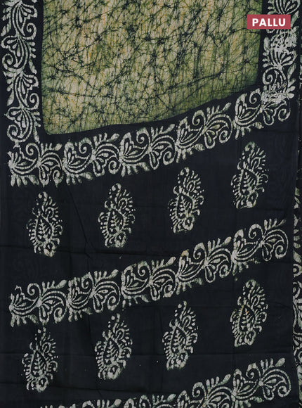 Batik cotton saree bottle green with allover prints and batik printed border