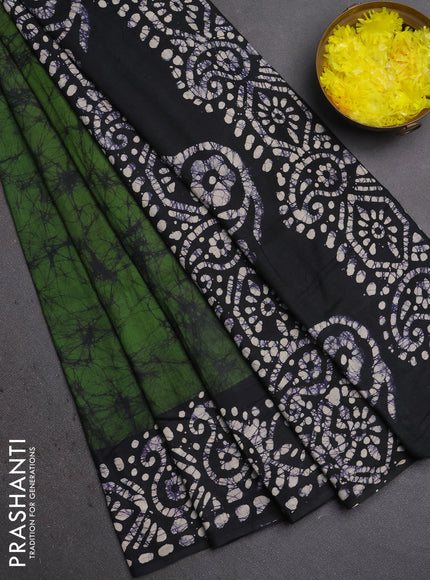 Batik cotton saree green with allover prints and batik printed border