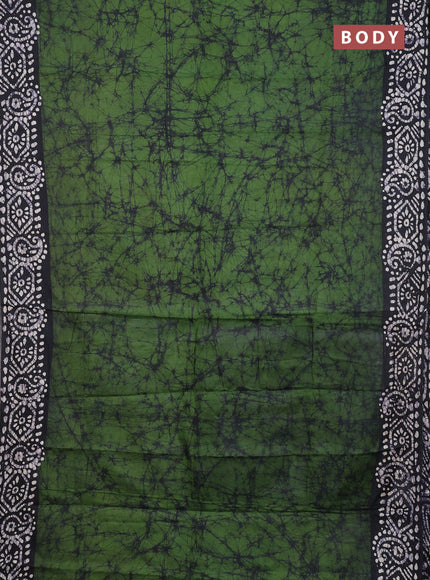 Batik cotton saree green with allover prints and batik printed border
