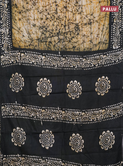 Batik cotton saree mustard yellow and bottle green with allover prints and batik printed border