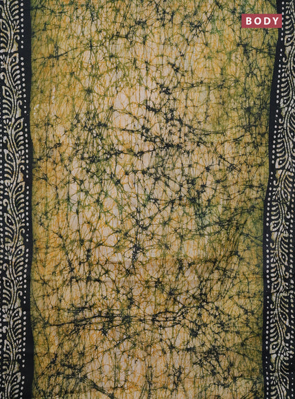 Batik cotton saree bottle green with allover prints and batik printed border
