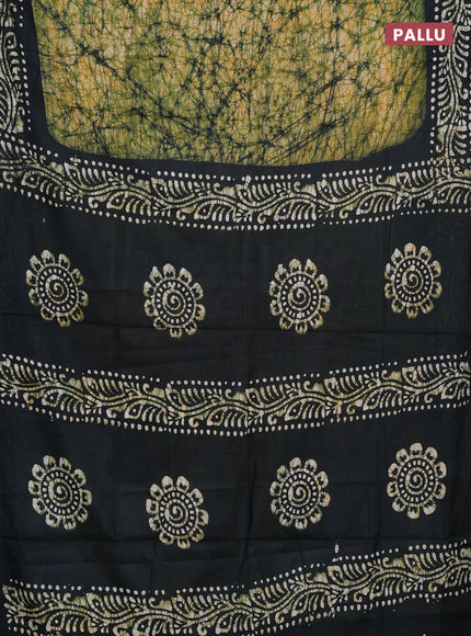 Batik cotton saree bottle green with allover prints and batik printed border