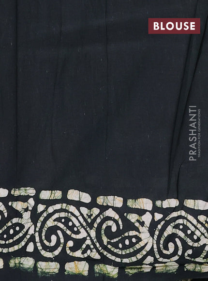 Batik cotton saree bottle green with allover prints and batik printed border