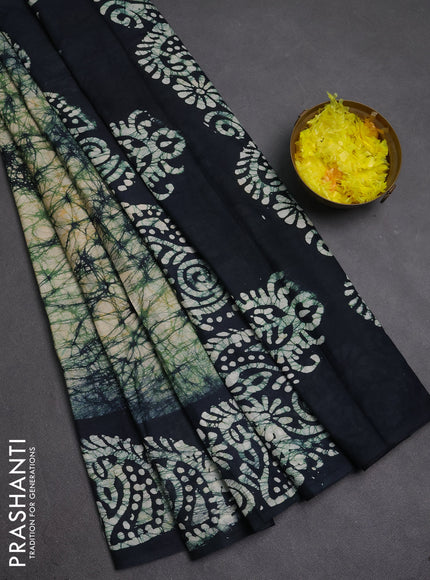 Batik cotton saree bottle green with allover prints and batik printed border