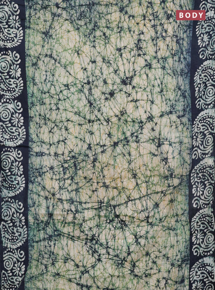 Batik cotton saree bottle green with allover prints and batik printed border