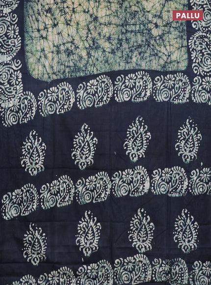 Batik cotton saree bottle green with allover prints and batik printed border
