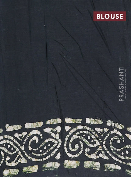 Batik cotton saree bottle green with allover prints and batik printed border