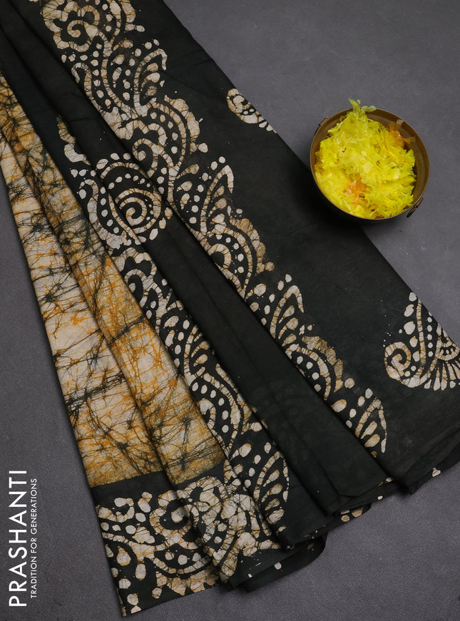 Batik cotton saree beige and black with allover prints and batik printed border
